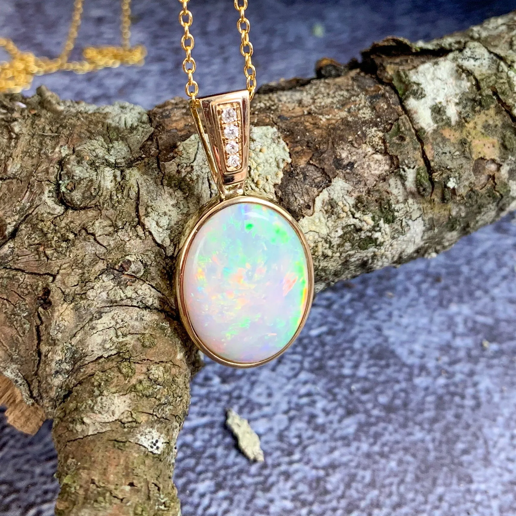 14kt Yellow Gold bezel set Oval Light Opal and diamond pendant