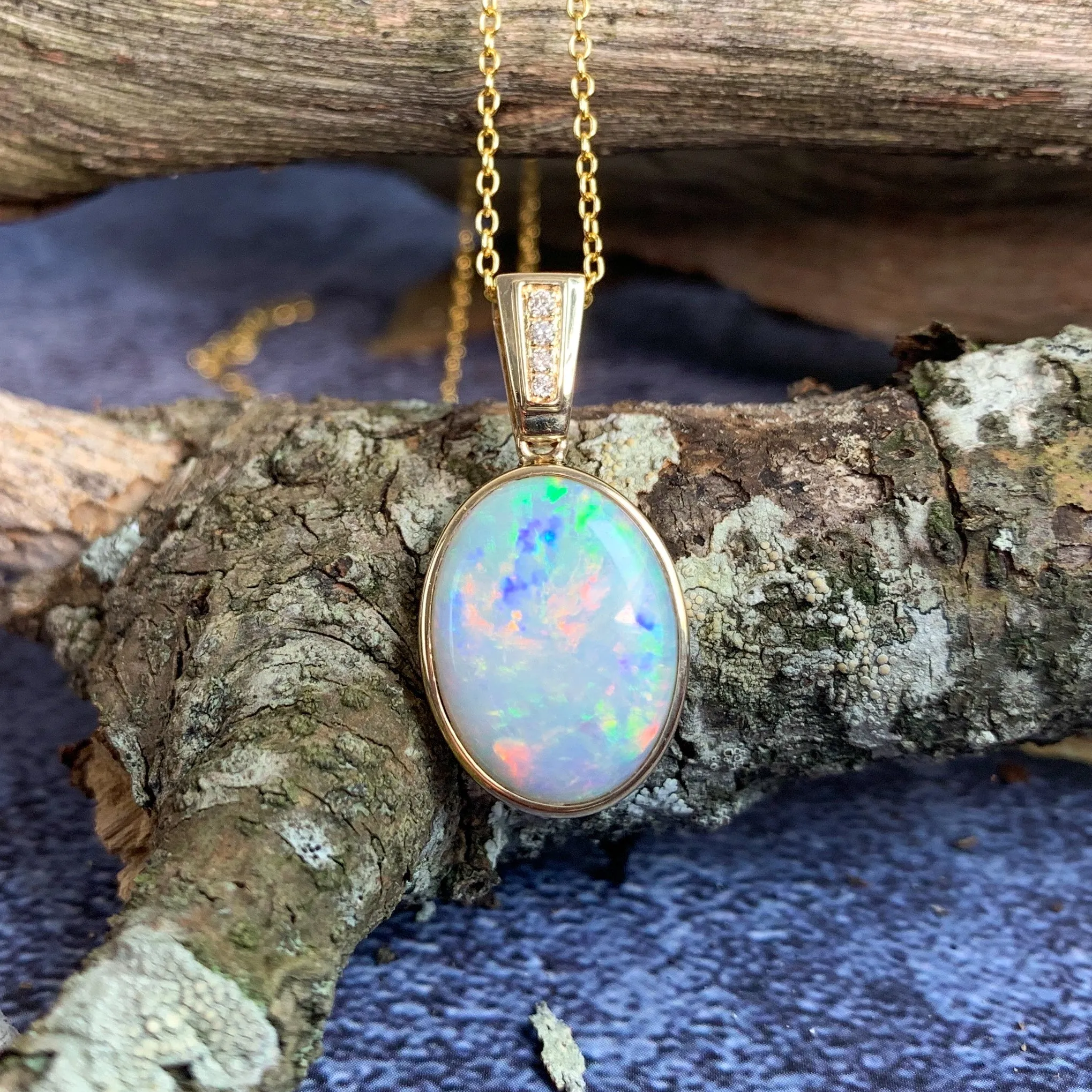 14kt Yellow Gold bezel set Oval Light Opal and diamond pendant